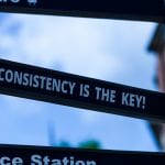 A road sign points to the left and says Consistency is the Key!