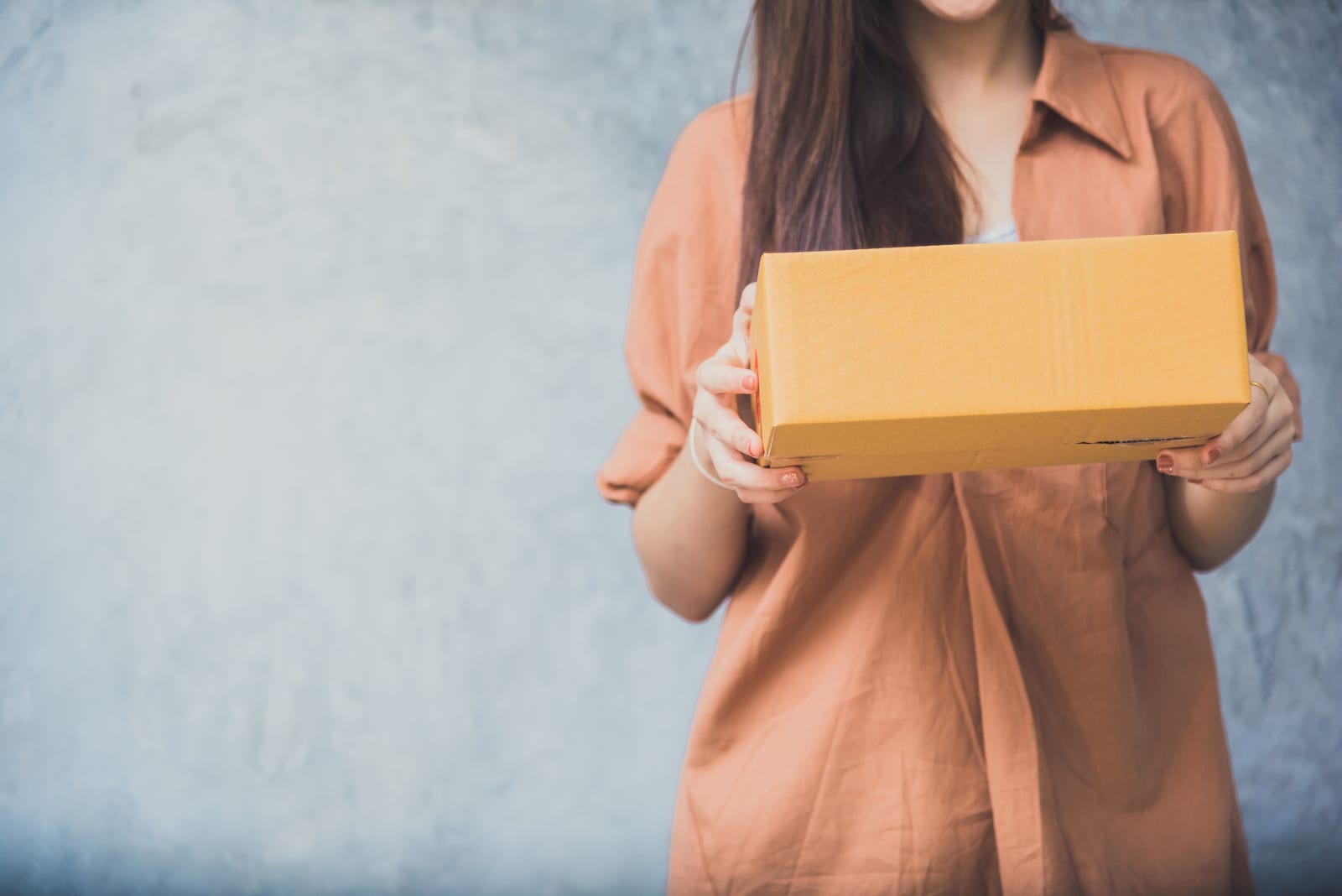 Woman holding parcel box for delivery to customer by logistic service. small business entrepreneur SME distribution warehouse concept. small owner home office and Online marketing product theme