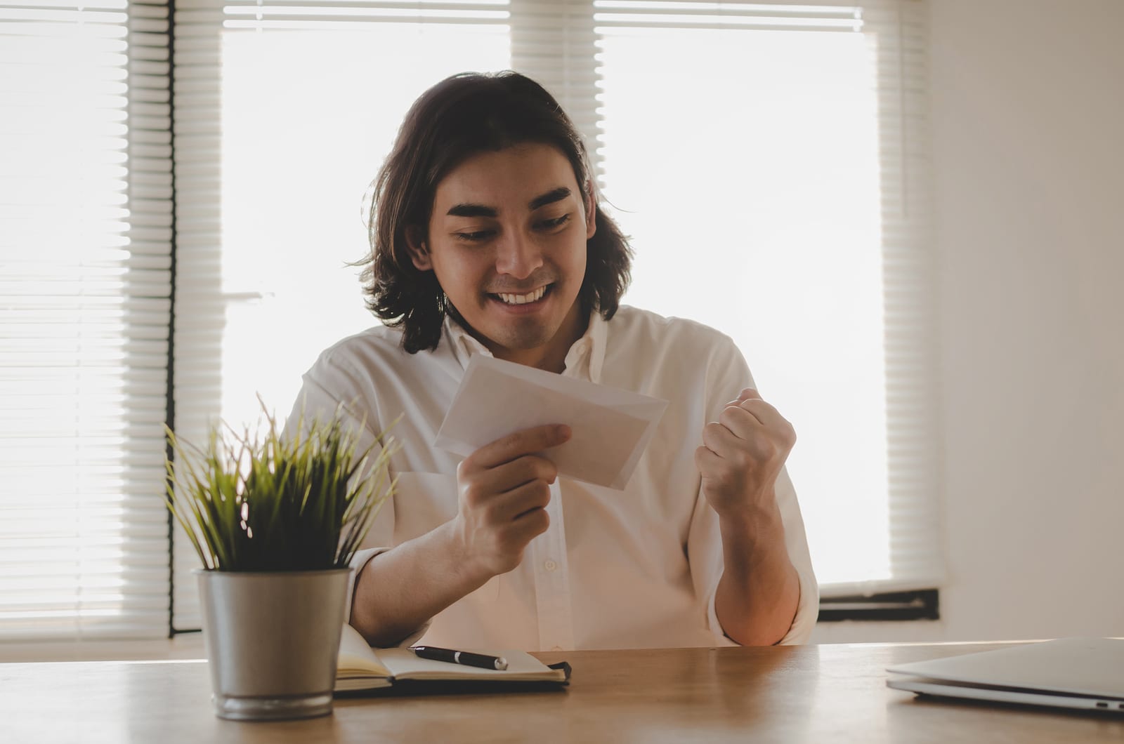 A young man is excited to receive a birthday card from his favorite business.