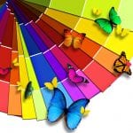 A bright color wheel sits with butterflies of matching colors flying above it.