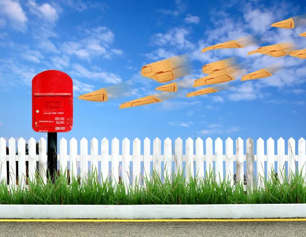 Red Postbox And Brown Envelope a red postbox and brown envelope with blue sky