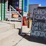 Shop local saturday, support your local weirdos, humorous sign written in chalk, supporting small local businesses