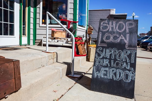 Shop local saturday, support your local weirdos, humorous sign w Shop local saturday, support your local weirdos, humorous sign written in chalk, supporting small local businesses