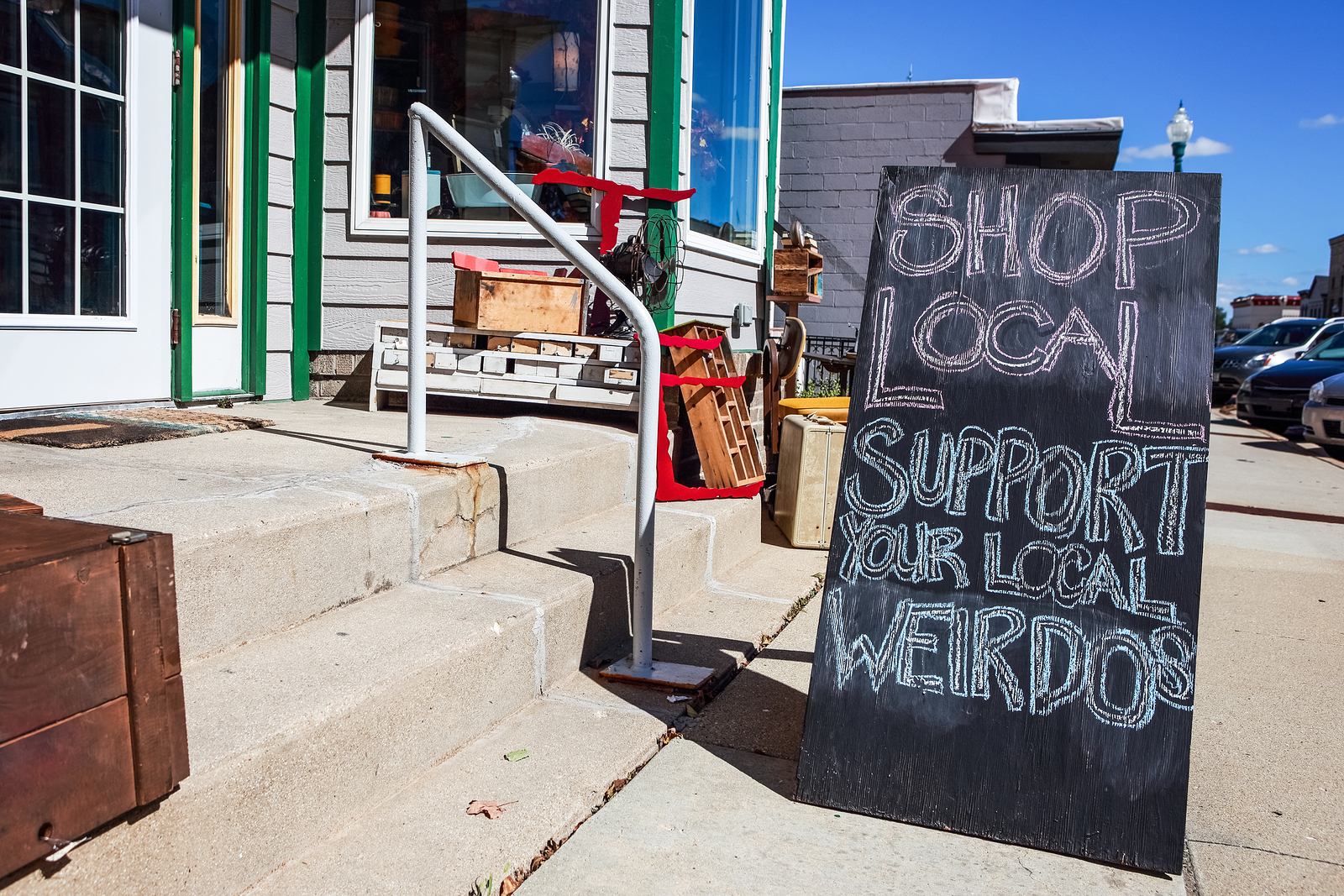 Shop local saturday, support your local weirdos, humorous sign written in chalk, supporting small local businesses