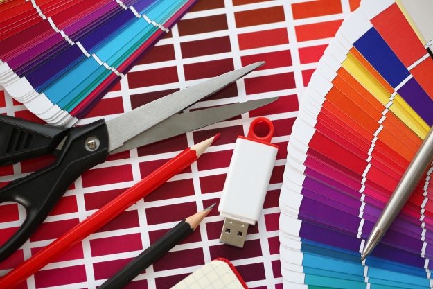 Stationery And Usb Flash Drive On Design Background. Color Print Stationery and USB flash drive on design background. Color print of pantone statistics offset organization gives customer an order products for distribution during promotion concept